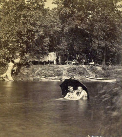 fiveoclockbot:  My friend Glen sent me this photograph with the caption “health and recreation, Iowa, 1880s.” Given that it is in the upper 90s in Minnesota right now, sitting under an umbrella in a lagoon sounds lovely right now… maybe swimming