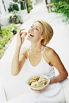 XXX  White women laughing alone with salad  photo