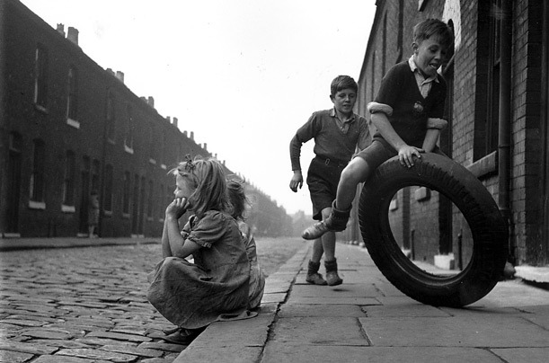 John Chillingworth
Children play with an old tyre on a street in Salford, Manchester, UK, 1951