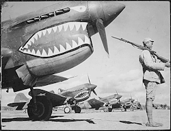todaysdocument:  Celebrating Shark Week - a squadron of shark-nosed P-40s of the Flying Tigers.  A Chinese soldier guards a line of American P-40 fighter planes, painted with the shark-face emblem of the “Flying Tigers,” at a flying field somewhere