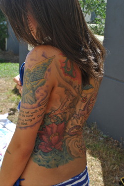 fuckyeahtattoos:  My Back :) It’s a Dragon, a Pheonix, a Lotus Flower, and a Cherry Blossom Tree. And the start of my sleeve which is Cupid Blindfolded and a quote from a  Midsummer Nights Dream… “Love looks not with the eyes but with the mind