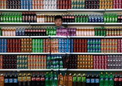 msnbc:  Chinese artist Liu Bolin waits for his colleagues to put a finishing touch on him to blend into rows of soft drinks in his artwork entitled “Plasticizer” to express his speechlessness at use of plasticizer in food additives, in his studio