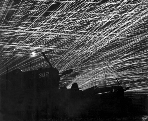 Anti-aircraft tracers light the sky over American planes in Okinawa, WWII.