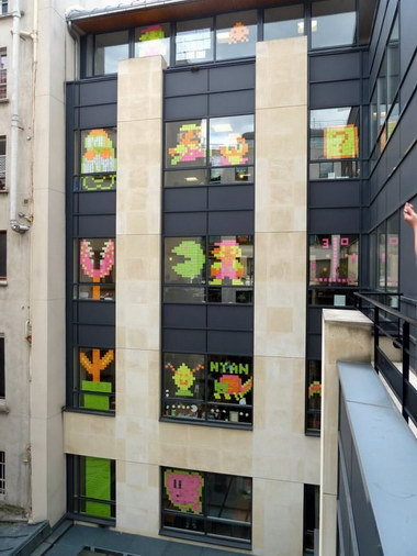 French people having "Post-It Wars" with workers from buildings across