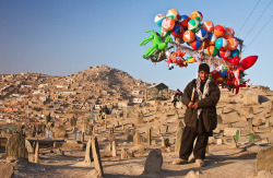 ghazalaa:  Man selling toys in a cemetery. Kabul, Afghanistan   !بهجة على قبور 