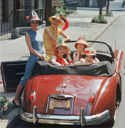 theniftyfifties: Models in fun hats in a Jaguar convertible, New York City, 1959.  Photo by Mar