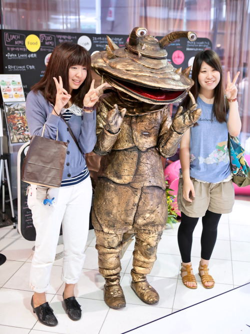 Japanese girls posing with a monster at Cafe de Kanegon in Shibuya.