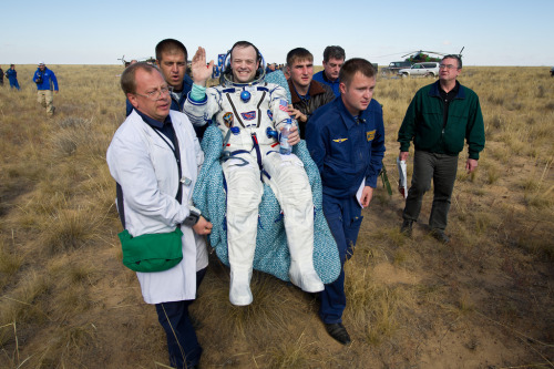 NASA Astronaut Ron Garan is carried to the medical tent shortly after the landing of Soyuz TMA-21 on