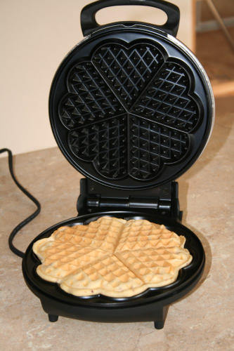 Score! Just found this amazing heart-shaped waffle maker by Cuisinart ($30) that would definitely make Egg(o) Waffles (and of course, regular waffles) all the more lovely.
Dudes: this would be a really cute anniversary or bday gift for your girl....