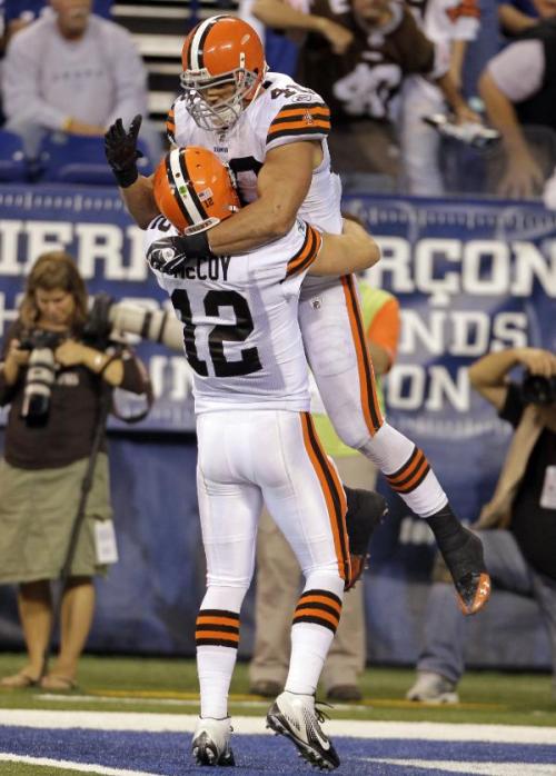 Cleveland Browns running back Peyton Hillis, top, jumps into the arms of quarterback Colt McCoy after scoring a touchdown late in the fourth quarter of an NFL football game against the Indianapolis Colts in Indianapolis, Sunday, Sept. 18, 2011. The...