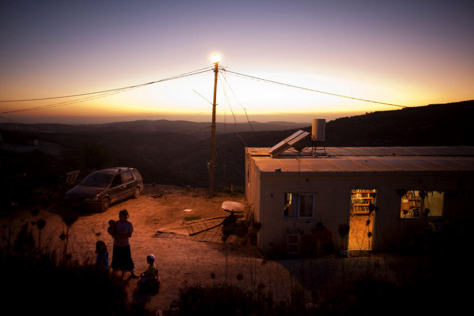 thepoliticalnotebook:
“ This was supposed to go up yesterday, as part of TPN’s weekday series of pictures of the day.
Picture of the Day. Havat Gilad, West Bank. A Jewish settler and her children play outside their home at a West Bank settlement...