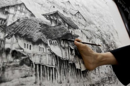allwhitewolves:  gaksdesigns:  41 year old Huang Guofu, from Chongqing, China, has learned to master the paintbrush with his mouth and right foot, after he lost both his hands in a childhood accident.  I love people like this.