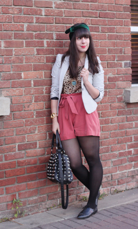 Pink shorts, leopard top, black tights and flats