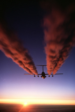 A C-141B Starlifter aircraft leaves four contrails behind it as it prepares for an airdrop during Operation Deep Freeze. Can airlift combat forces, equipment and supplies, and deliver them on the ground or by airdrop, using paratroop doors on each side