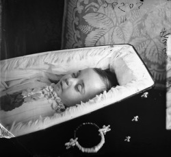  A postmortem photograph of a small child in a beautiful coffin. 