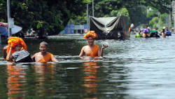 inothernews:  Buddhist monks walk through chest-high water as floods inundate Ayutthaya province in Thailand on Monday.  Flooding during an unusually heavy monsoon season has caused nearly 500 deaths to date and millions of evacuations in Thailand and