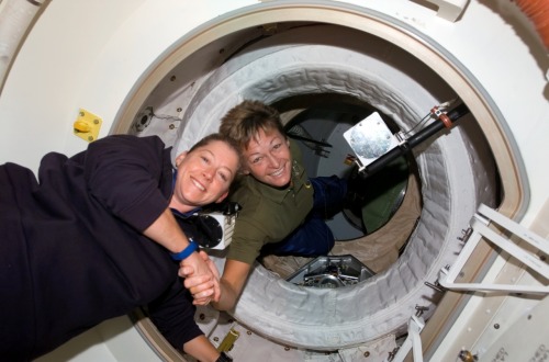 Pam Melroy (left), Commander of STS-120, is welcomed aboard the ISS by Expedition 16 Commander Peggy