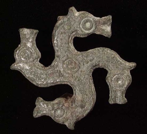 GALLO-ROMAN SWASTICA FORM BROOCH, ca. 4th-6th century. Each arm of the swastica ending in a horse he