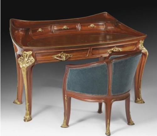 LOUIS MAJORELLE (1859-1926)  ORCHIDÉES BUREAU AND FAUTEUIL, CIRCA 1905  carved mahogany with gilt-br