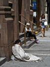 I took this photo in NYC last year. To me it says, one of us chooses to sit here, while the other has nowhere else to go. One is black, the other is white. One wears Chanel, while the wears rags. They share the same country, the same street, the same...