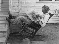 Farmer reading his farm paper photo by George