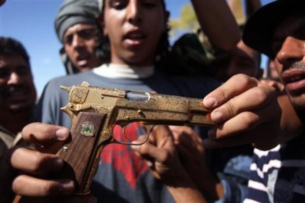 atrofiarte:  bensasi:  Ahmed El Shebani, 18 years old; Holdings #Gaddafi’s gun,