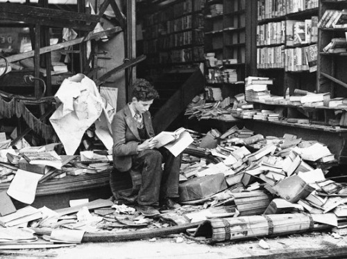bookshelves:  A boy sits amid the ruins of a London bookshop following an air raid on October 8, 1940, reading a book titled “The History of London.” 