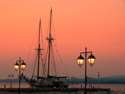 Jtkfr:  Sunset On Dapia With Traditional Vessel And Lamp Posts. Spetses Island, Saronic