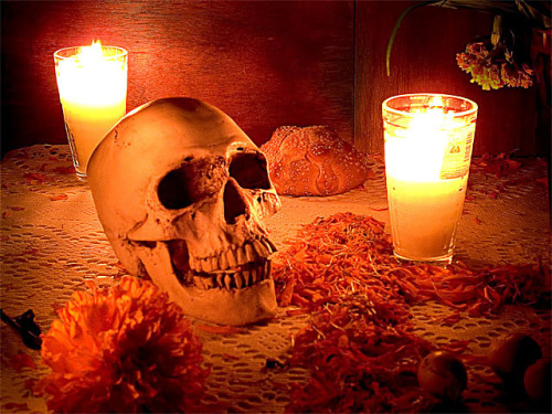 Altar with skull, marigolds, and pan de muerto.