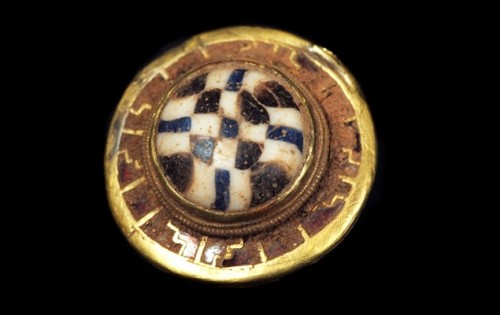 A small stud from the Staffordshire Hoard. The stud uses the millefiori, literally meaning &ldquo;on