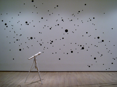 freshphotons:  Mind and Body, 2005, Chris Saunter. 300+ circles are cut from the gallery walls and then used to construct a telescope that aims back at the wall to study the newly constructed star field made by the holes. Via. 