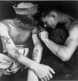  An American sailor being inked by a shipmate