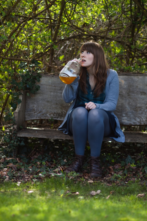 Blue tights, dark brown boots and greenish blue tartan shirt