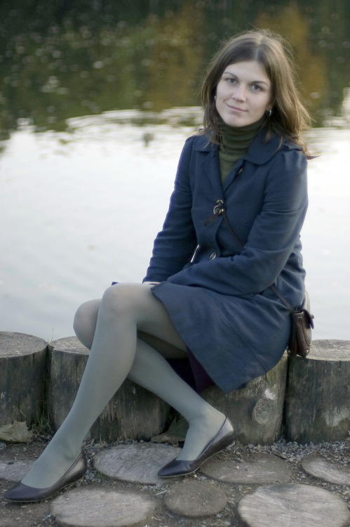 Greyish green tights, flats and blue long coat