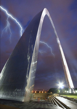 thefrogman:  This is the Gateway Arch. It is located in my home town of St. Louis. Built from stainless steel panels, the Arch uses a negative ionic charge to repel water molecules. It essentially controls the weather for the downtown area. It’s unique