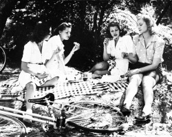 vintagegal:  Rita Hayworth eating chicken leg  (L-R) Minerva Griswold, Virginia Hovey and Jane Hopkins enjoy jelly sandwiches during picnic on the grass in the Hollywood Hills. June 1940 Photographer-Peter Stackpole