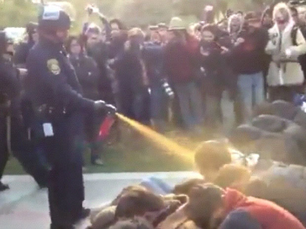 nationalpost:  Screen grab of police in riot gear spraying what appears to be pepper