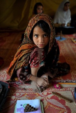  An Afghan girl poses for a picture as she