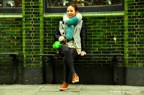 Cognac shoes, black opaque tights and beige coat with black leather sleeves