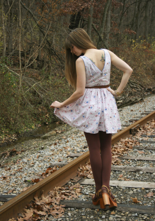 Brown tights and wooden heels + white dress with subtle red and blue flower pattern