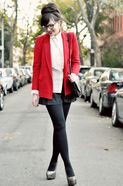 Keiko Lynn in black tights, shiny silver heels, shorts and bright red coat