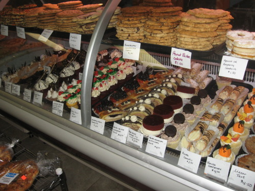 Sweets!1: The display case at a local bakery. I bought a little vanilla cheesecake with oreo mousse,
