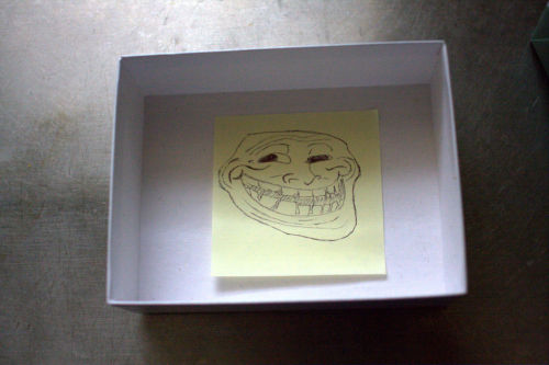    so my dad told me there was something for me as an apology for the status above.i go into the kitchen & see a box of wonderful cookies!right? WRONG. i open the fucking box & my dad drew a freaking troll face & put it inside an EMPTY box.