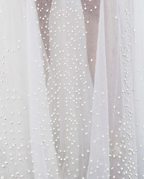 pearls hand-sewn on a givenchy haute couture gown which took a total of 8 months to complete