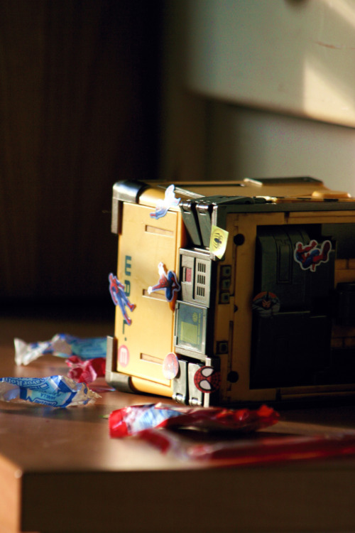 I came home to find this on my desk: Wall-E, cubed up, passed out, surrounded by candy wrappers from