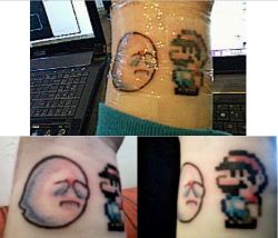 fuckyeahtattoos:  here’s a picture of the Mario + Boo tattoo i got today (12/21/11) first in the plastic wrap and then finally unwrapped (still swollen though). i got it at Guru Tattoo in San Jose, CA from Josh.the meaning behind this tattoo: i’ve