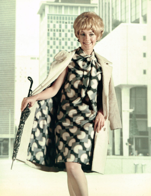 dtxmcclain:  Looks like PacMan is eating her dress. Model for Old Glory fabrics, 1960s, with downtown Dallas buildings in background.