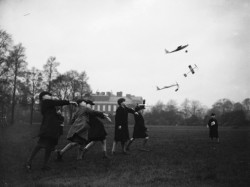  A group of schoolboys hurl their model aeroplanes into flight at Kensington Gardens, London, 1937 