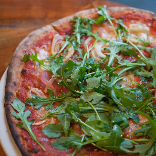 Wood-fired pizza with smoked mozzarella, pickled red onion, Parmesan cheese, fennel, arugula and chili flake at Oliveto Cafe, 5655 College Ave., Oakland, CA.