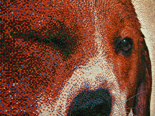  “At a distance of 16 feet, the sprinkles blur, tricking the human eye into believing that it is looking at a large photograph. Only when you closely examine the work do you realize that it has been created entirely with tiny spheres of candy. Taking